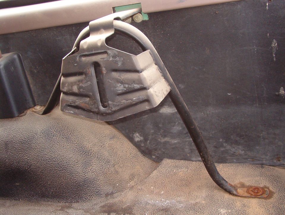 Tailgate or spare-tire latch mechanism inside a vehicle panel