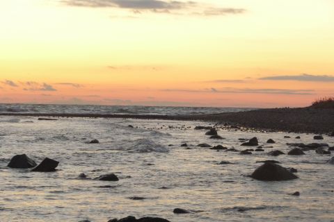 1989 Ford F-150 - A tranquil scene of waves washing over rocks on a beach during a vibrant sunset.