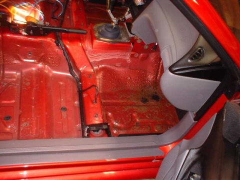 1994 Ford Mustang - Interior view of a 1994 Ford Mustang, focusing on the floor pan and console.