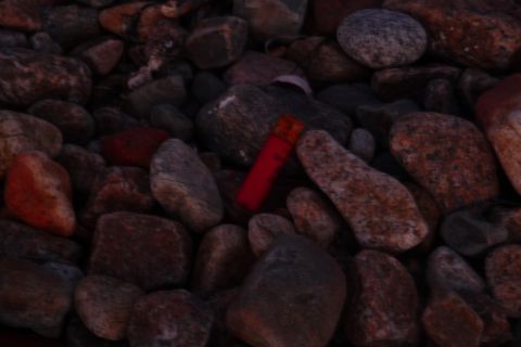 1989 Ford F-150 - A red object is visible amongst a pile of rocks.