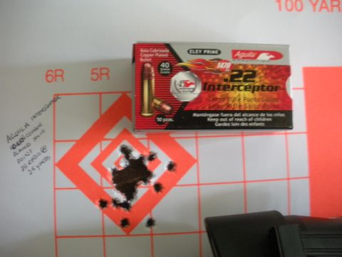 1996 Ford Bronco - Ammunition box and target with bullet holes from a shooting range.