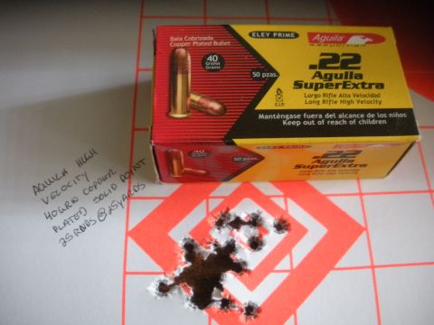 1996 Ford Bronco - Aguila .22 SuperExtra ammunition box sits next to a target with bullet impacts.