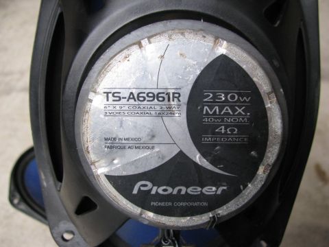 2004 Ford Crown Victoria - Label details for a Pioneer TS-A6961R 6" x 9" coaxial 3-way speaker, showing specifications like 230W max power and 4 ohm impedance.