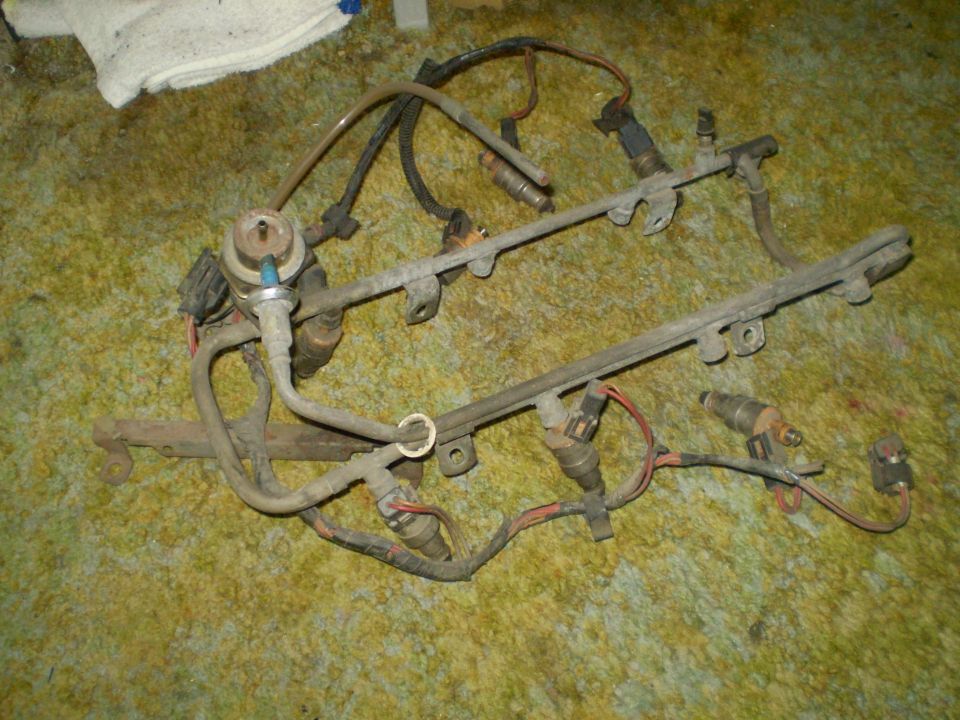 Fuel injector rail assembly with injectors and fuel pressure regulator removed from a vehicle