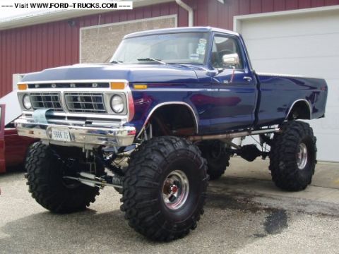 1977 Ford F-150 - This lifted 1977 Ford F-150 pickup truck is parked in front of a garage door.