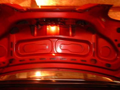 1994 Ford Mustang - The interior of a red car trunk is visible, illuminated by a light source. A watermark for Supermotors.net is present in the lower right co…