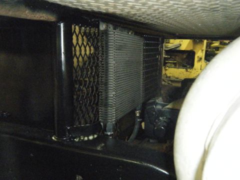 1978 Ford Bronco - Underside view of a vehicle showing a transmission cooler and surrounding components.