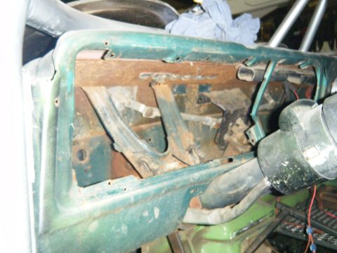 1978 Ford Bronco - Interior view of a green dashboard showing significant rust and missing components, with the steering column in view.