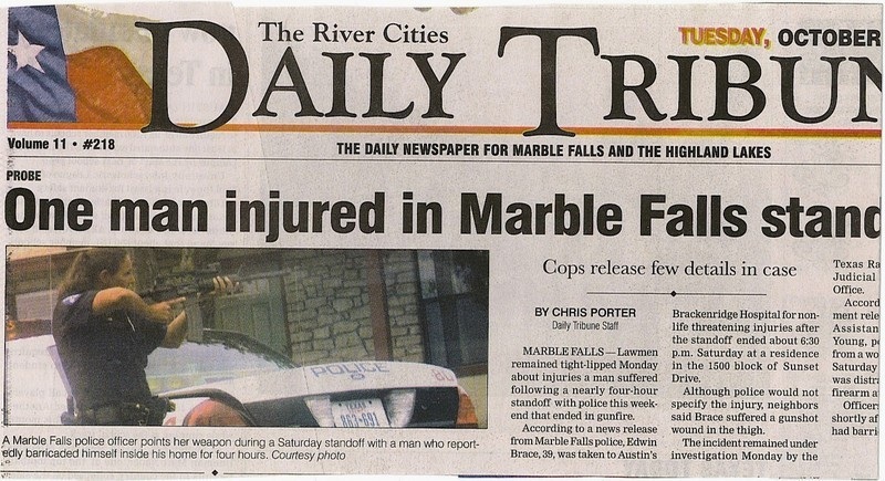 Newspaper article about a police standoff with a police car visible