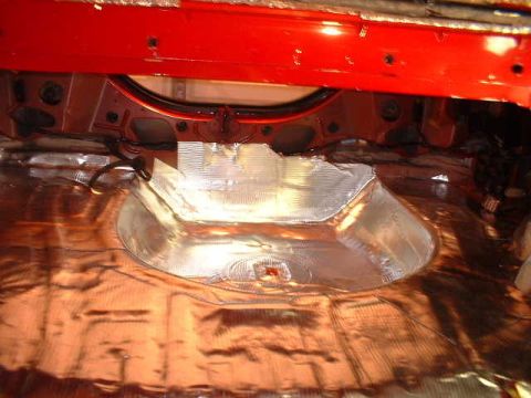 1994 Ford Mustang - Soundproofing is being applied to the interior of a vehicle's trunk area.