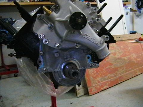 1996 Ford Bronco - Engine block with Edelbrock intake manifold on a stand, with plastic wrap covering the lower section.