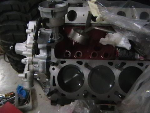 1996 Ford Bronco - Close-up view of an engine block, showing the cylinders and pistons, with a distributor cap attached.
