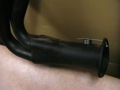 1996 Ford Bronco - A close-up view of a black exhaust manifold with a sensor attached.
