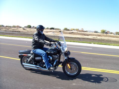 1996 Ford Bronco - Rider on a motorcycle traveling down a highway on a clear day.
