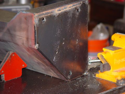 1993 Ford Bronco - A metal bracket is secured in a vise, ready for modification or assembly.