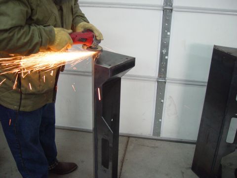 1993 Ford Bronco - Grinding a metal part with an angle grinder, sparks flying.