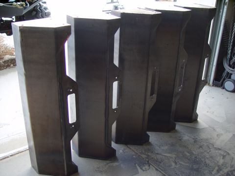 1993 Ford Bronco - Several custom metal bumpers are lined up in a workshop setting.