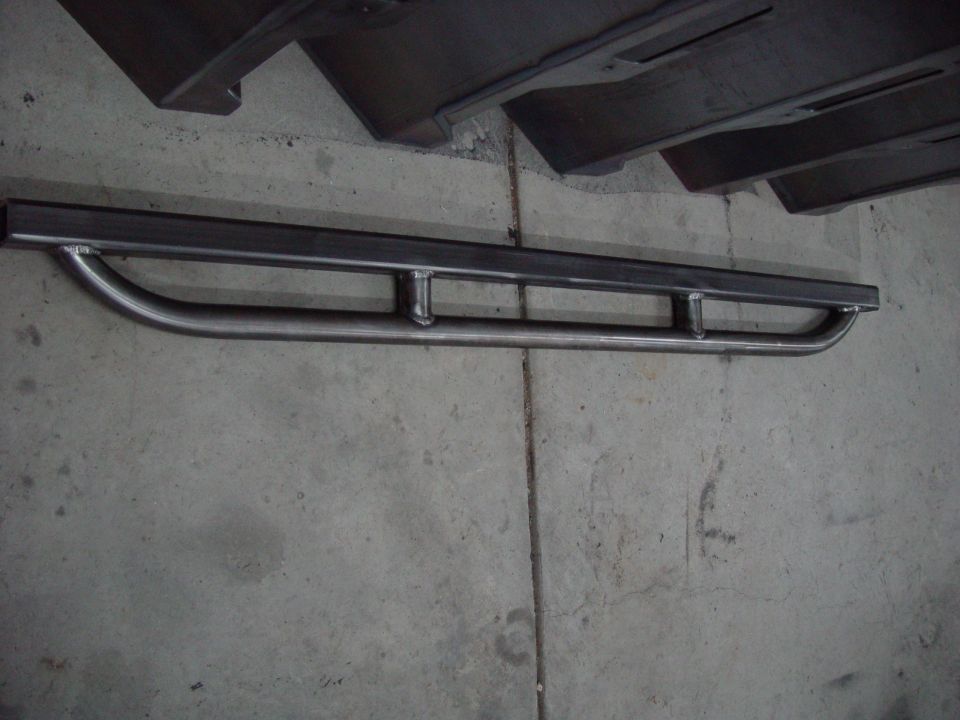 Custom steel rock sliders with a curved step and multiple support bars