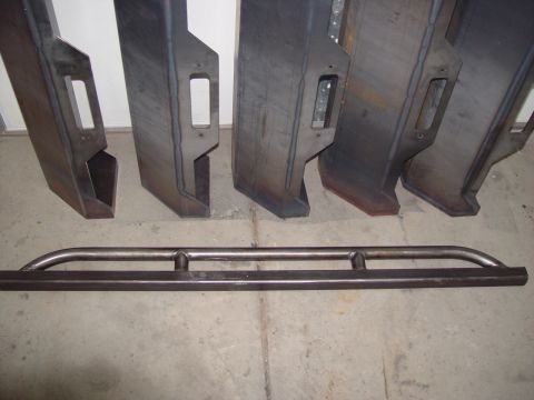 1993 Ford Bronco - Custom fabricated steel bumpers and rock sliders are displayed on a workshop floor.