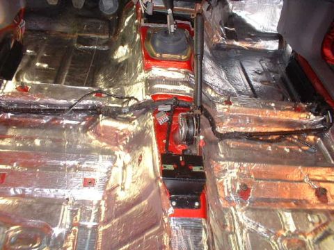1994 Ford Mustang - The interior of a 1994 Ford Mustang is shown with sound deadening material applied to the floor and transmission tunnel.