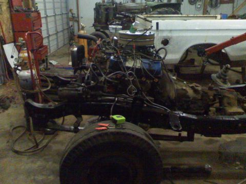 1979 Ford F-250 - The truck's chassis and engine are exposed in a workshop setting, with a white cab in the background.
