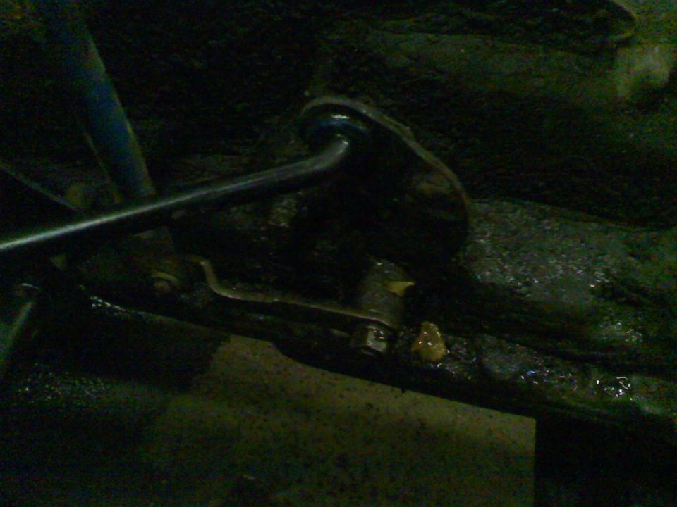 Close-up of a vehicle's suspension linkage and frame