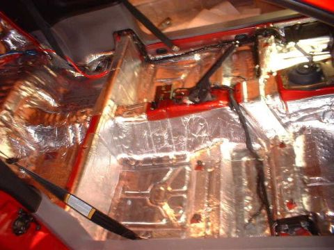 1994 Ford Mustang - Sound deadening material is being installed on the floor pan and transmission tunnel of a vehicle.