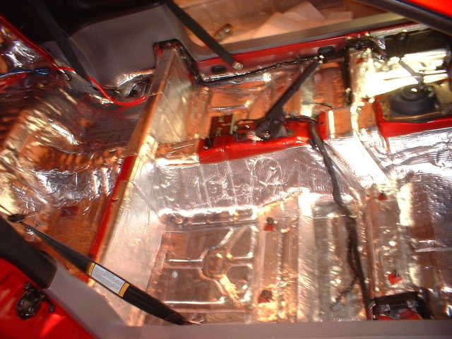 Car interior with soundproofing material applied to the floor and lower panels