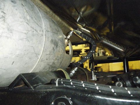 1978 Ford Bronco - This image shows a close-up view of a large tank and associated plumbing, likely part of a vehicle's fuel or air system.