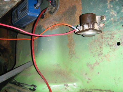 1978 Ford Bronco - Close-up of a starter solenoid and ignition module, with visible wiring and green painted metal.