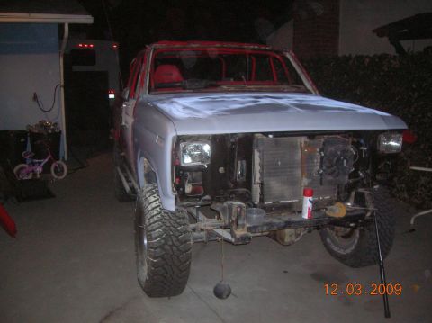 1985 Ford Bronco - This Ford Bronco is undergoing repairs, with its front end disassembled and primer applied to the hood.