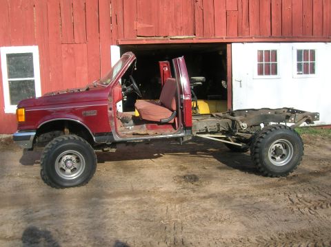 1996 Ford Bronco - This 1996 Ford Bronco is shown as a chassis with its cab, parked in front of a red barn.