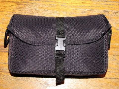 1984 Ford Bronco - This black fabric case with a buckle closure is shown on a wooden surface. The Supermotors logo is visible in the lower right corner.