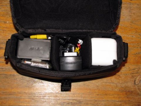 1984 Ford Bronco - Contents of a camera bag, including various electronic accessories and cables.