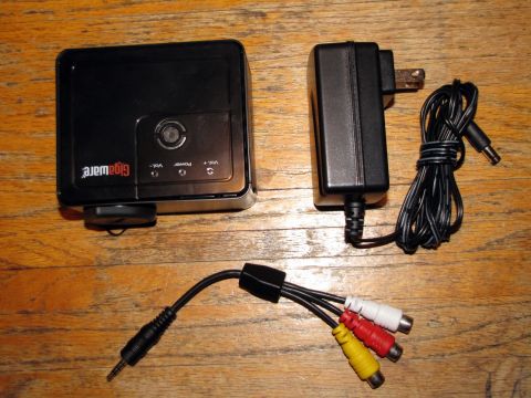 1984 Ford Bronco - This photo shows a Gigaware portable media player with its power adapter and AV cables.