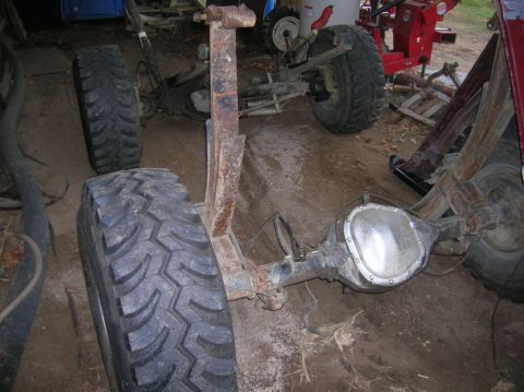 1996 Ford Bronco - Rear axle and suspension parts are visible in this cluttered garage setting.