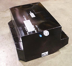 1986 Ford Bronco - A black metal fuel tank is shown, with some labels and a cap on top.