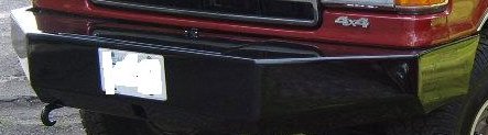 1989 Ford Bronco - The front of a red 1989 Ford Bronco is visible, a black bumper and a license plate.
