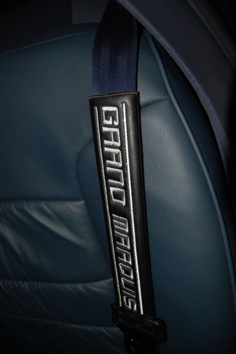 1985 Mercury Grand Marquis - Seat belt shoulder pad embroidered with 'GRAND MARQUIS' text.