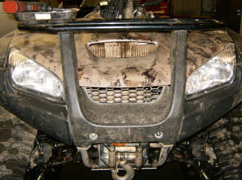 2000 Ford E350 - ATV front end covered in mud, with a winch and tow hook visible below the grille.