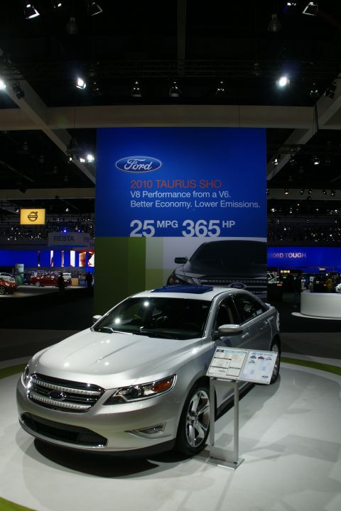 1993 Ford Taurus - A silver 2010 Ford Taurus SHO is displayed at an auto show with its specifications listed on a nearby sign.