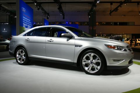 1993 Ford Taurus - This silver sedan, likely a Ford Taurus from around 2009, is displayed at an auto show.