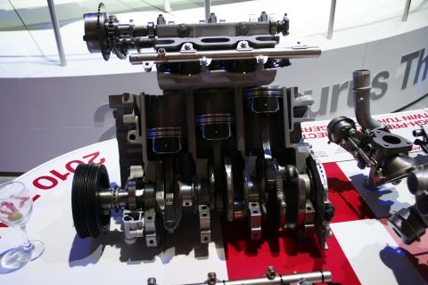 1993 Ford Taurus - A display shows a cutaway engine, likely from a Ford Taurus, with visible internal components.