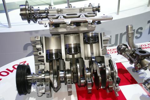 1993 Ford Taurus - A detailed view of an engine's internal components, including pistons and crankshaft, displayed at an auto show.