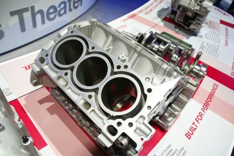 1993 Ford Taurus - Engine block and crankshaft assembly displayed at an auto show, likely for educational purposes.