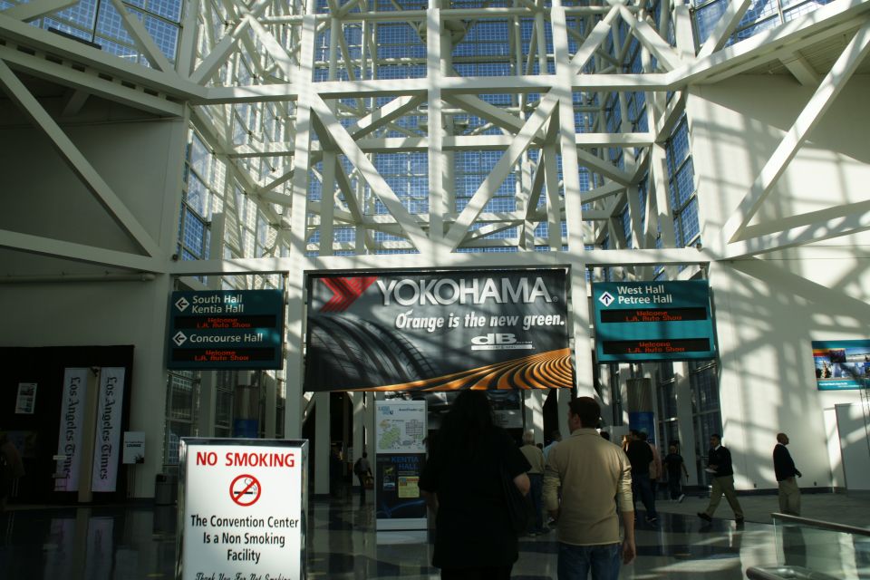 Convention center interior with Yokohama tire ad and directional signs