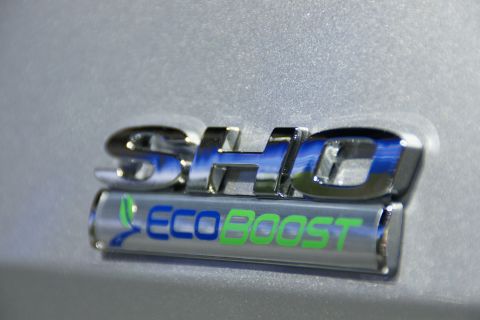 1993 Ford Taurus - A close-up shot focuses on the SHO and EcoBoost badging on a vehicle.