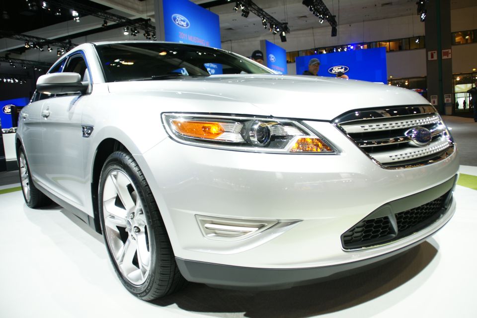 Silver Ford Taurus with chrome grille and headlights on display