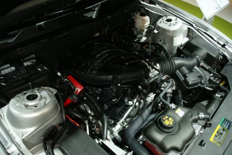 1993 Ford Taurus - Close-up view of a car's engine compartment, showing various hoses, wires, and engine components.