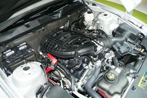 1993 Ford Taurus - Close-up view of a car's engine bay, highlighting the intake manifold and various engine components.